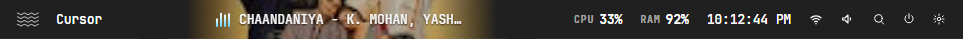 Shibui status bar with the active app, the current song, CPU, memory, the clock, and system icons.
